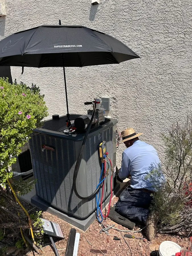 HVAC technician performing outdoor AC maintenance in Katy
